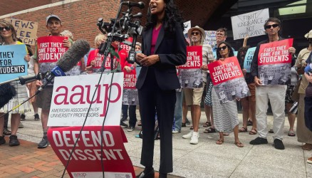 A lawyer speaks into a microphone outside the AAUP v, Rubio trial in Boston.